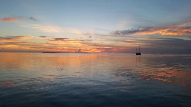 istock Two sailboats in Florida Bay at sunset. 2155624569