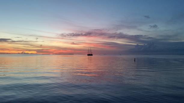 Two sailboats in Florida Bay at sunset.
