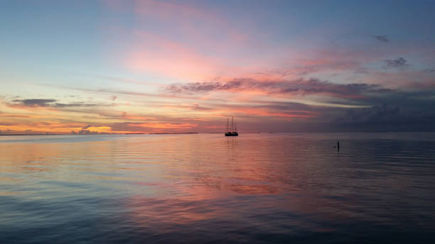 istock Two sailboats in Florida Bay at sunset. 2155624603