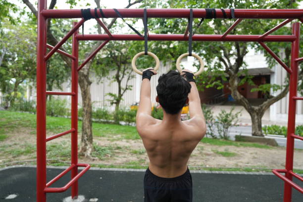 istock Asian man practicing gymnastics doing gymnastics bar and hoop exercises and stretching and resting for sports. 2155625962