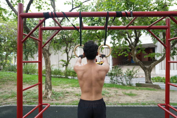 istock Asian man practicing gymnastics doing gymnastics bar and hoop exercises and stretching and resting for sports. 2155625993