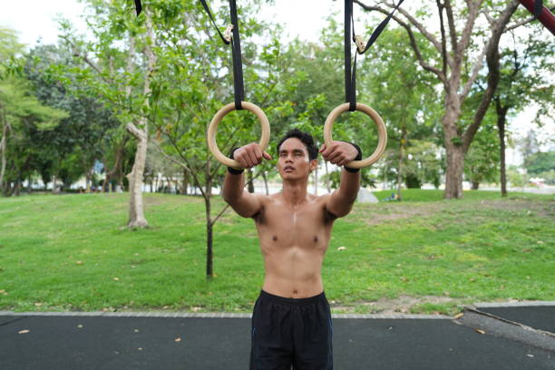 istock Asian man practicing gymnastics doing gymnastics bar and hoop exercises and stretching and resting for sports. 2155626327