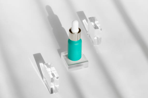 istock teal serum bottle surrounded by crystal blocks casting elegant shadows on white background 2155630174