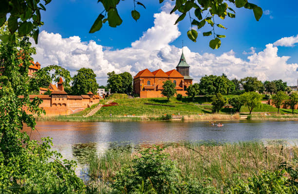 istock Ancient medieval village church reflected in the river water 2155631365
