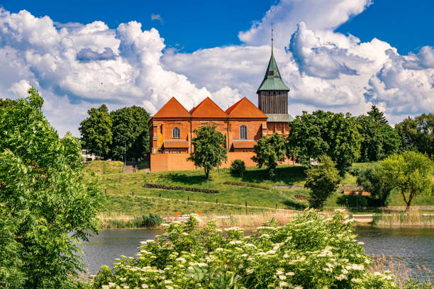 istock Ancient medieval village church reflected in the river water 2155631366