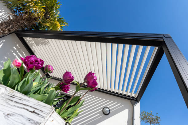 istock eco friendly bioclimatic aluminum pergola shade structure surrounded by landscaping. bouquet of tulip on the foreground 2155636827