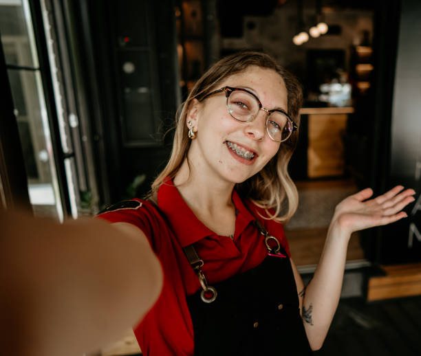 istock Happy young female barista making selfie in a cafe 2155641285