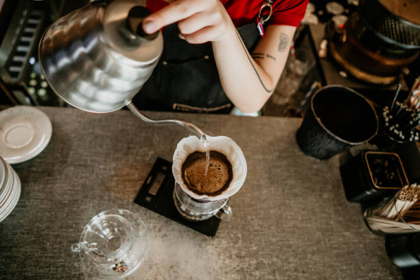 istock professional female barista preparing filter coffee 2155643030