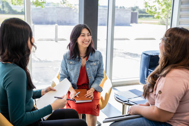 istock Professional coworkers use portable solar panel to charge devices during meeting in modern office 2155643178
