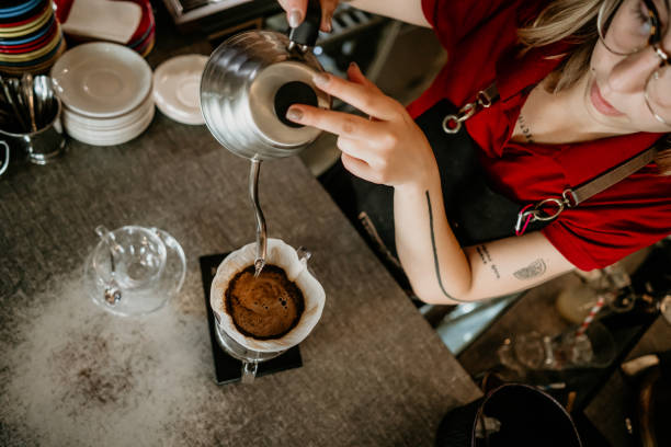 professional female barista preparing filter coffee