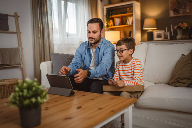 istock Father hold credit card buy online on tablet while son hold package 2155648352
