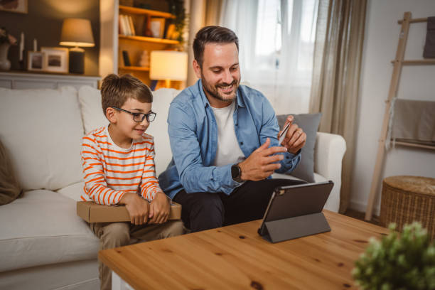 istock Father hold credit card buy online on tablet while son hold package 2155648353