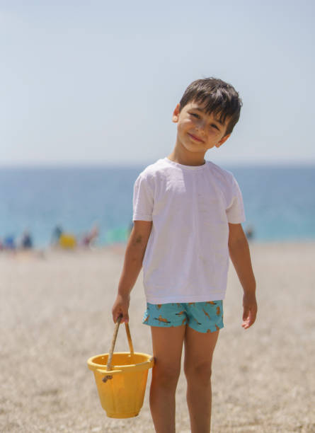 Cute little boy playing in the sand on the beach