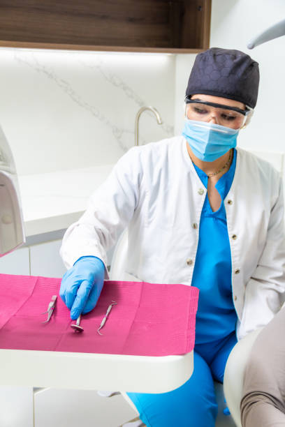 istock Female latin hispanic dentist grabbing dentistry metallic instruments or tools ready for dental procedure. Dentist occupation concept. 2155649896