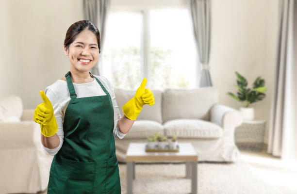istock Asian housekeeper wear gloves apron 2155653057