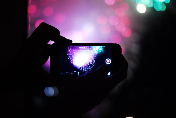 istock A person is capturing a photo of fireworks using a mobile phone 2155655736