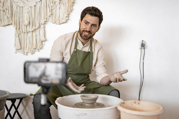 istock Male potter creating ceramics while recording video blog 2155657882