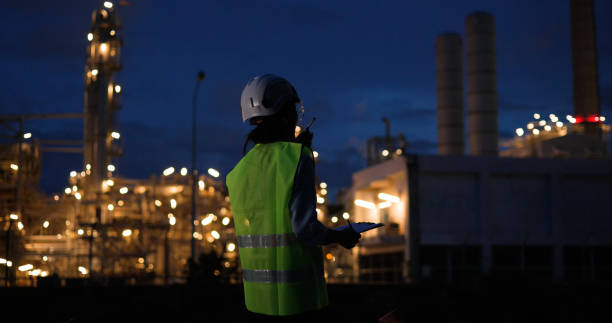 istock Senior female industrial engineer excelling with a digital tablet during the night shift at a chemical industrial site. 2155660397