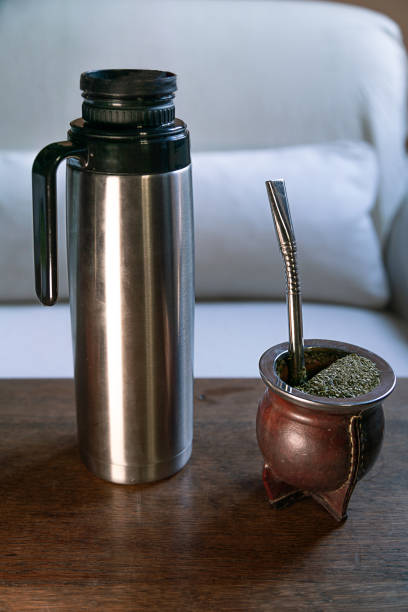 A mate tea on the table, near a thermos of hot water.