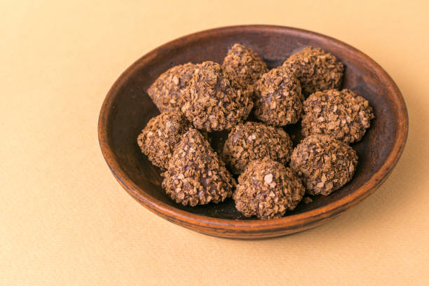 istock Handmade Chocolate Truffles in a Rustic Ceramic Bowl on Beige Background 2155666795