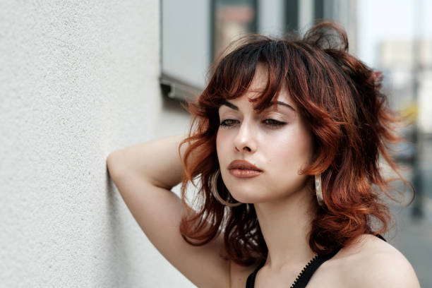istock Nostalgic portrait of young woman leaning on white wall. 2155668895