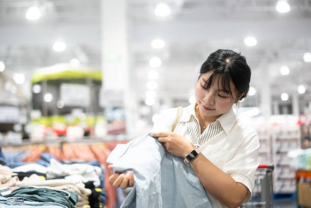istock Woman choosing clothes in store 2155672170