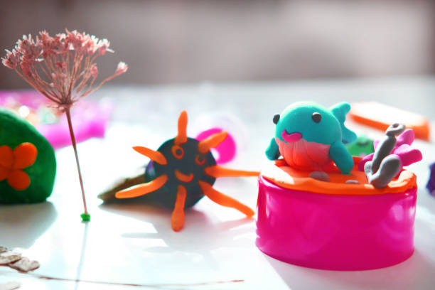 Child making crafts using natural dry plants, flowers, leaves and use plastic corks, stones, plasticine. Back to school. Making diorama, dolls. Ideas for children's art. Performance on the table