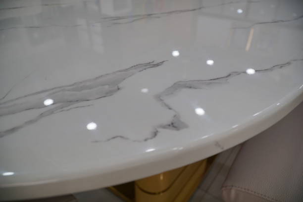 istock Luxury Marble stone top dining table and chairs set with golden color metal base and frame. Luxurious Dining set. Details of close up of chair and frame of table. 2155677682