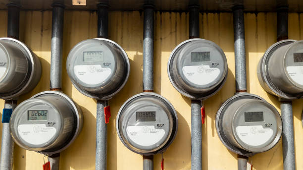 istock Several digital electric meters installed on the wall at an apartment building. 2155677871