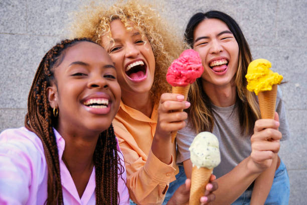 istock Three multiracial happy friends with ice creams taking a selfie in summer. 2155680081