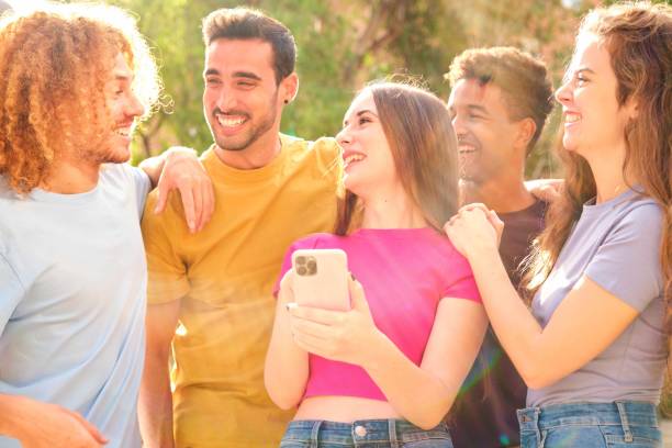 istock Cheerful young multiracial friends looking at smart phone. 2155681091