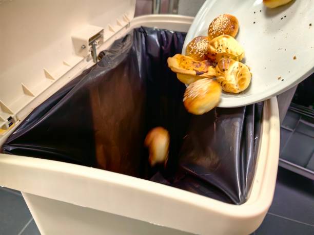istock throw leftover food into the trash can. 2155681394