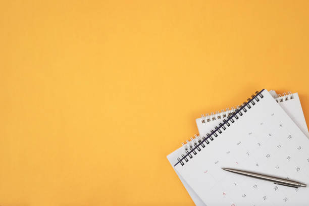 istock A pen with calendar on yellow background. 2155681537