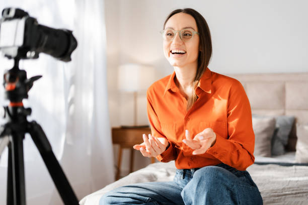 istock Smiling cheerful young woman blogger making video content for sharing 2155681625