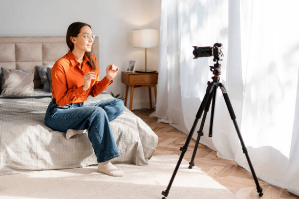 Happy cheerful young woman blogger making video content for sharing