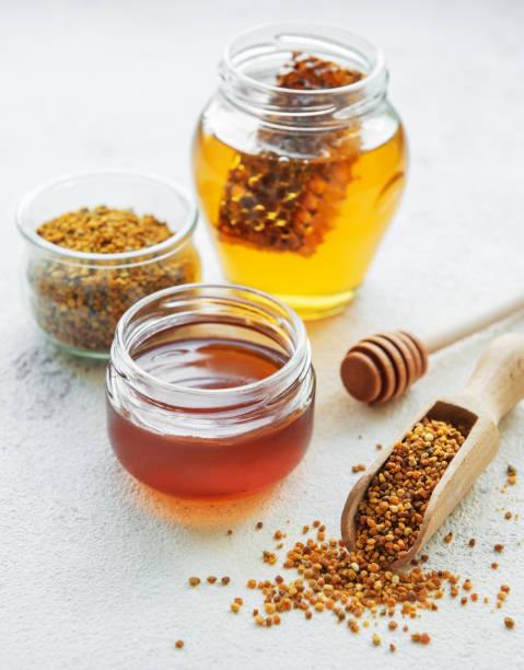 istock Raw organic bee pollen and honey in jars. 2155681732
