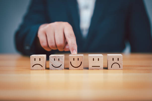 istock best excellent business services rating customer experience. Satisfaction survey concept. Hand of a businessman chooses a smiley face on wood block cube. 5 Star Satisfaction. 2155681935
