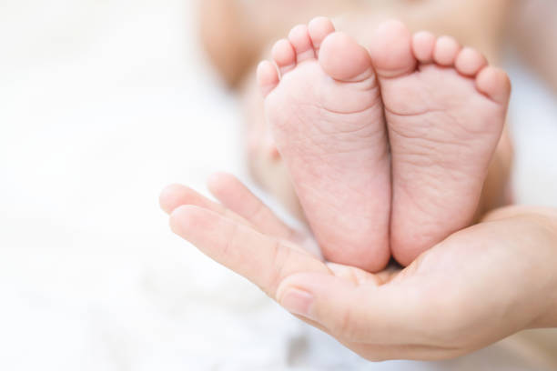 istock mother and father take care newborn with warmth 2155682785