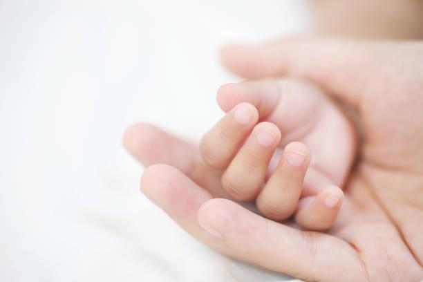 istock mother and father take care newborn with warmth 2155682869