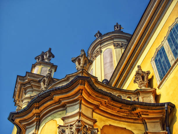 Cultural Monument: A historic buildings facade with statues and gilded accents, set against a blue sky, reflecting cultural pride. St. George's Cathedral in the city of Lviv.