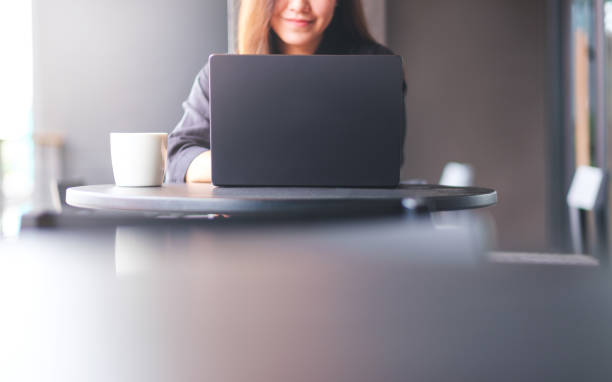 istock Closeup image of a young woman working and typing on laptop computer in cafe 2155683114