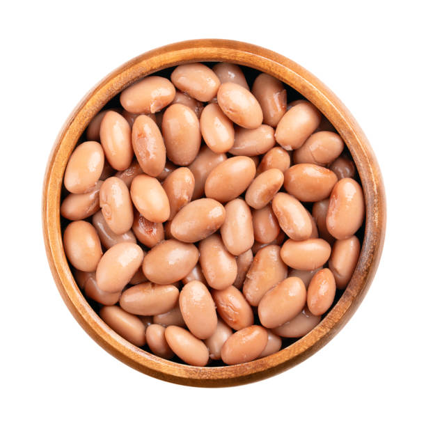 Borlotti beans in opened can. Cooked and canned cranberry beans, a hazelnut-colored variety of the common bean, Phaseolus vulgaris. Vegetarian staple food. Isolated, from above, close-up, food photo.