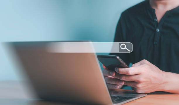 istock Person Using Smartphone and Laptop for Search 2155684404