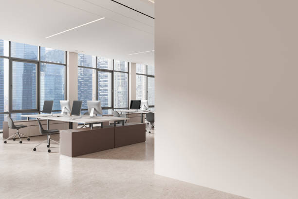 istock An office interior with desks and computers, modern design, in a high-rise with city views, concept of a professional workplace. 3D Rendering 2155684792