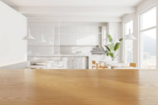 istock Wooden table and blurred cafe interior with seats and table near window. Mockup 2155685526