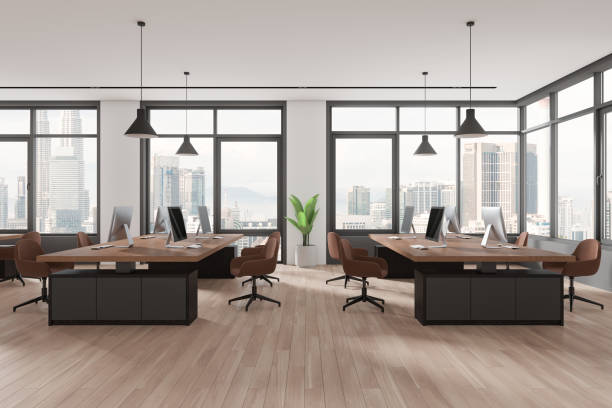 istock Stylish coworking interior with pc computers on desks in row, panoramic window 2155685835