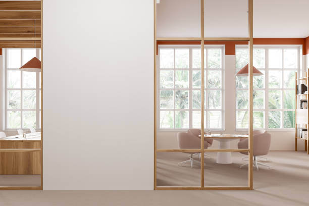 istock Cozy office room interior with meeting board and armchairs, window. Mock up wall 2155685931