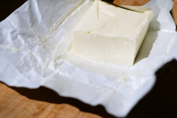 istock butter in a package close-up lies on a wooden table 2155686304