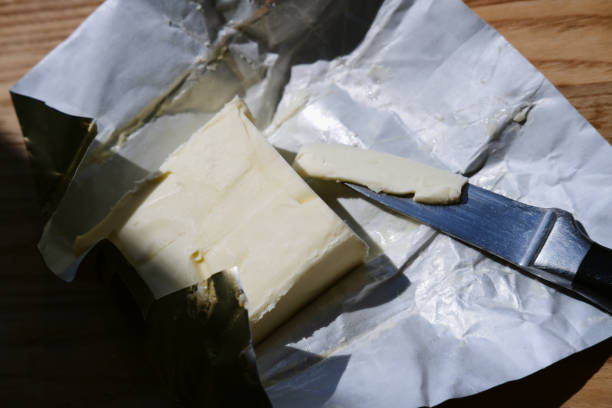 istock butter in a package close-up lies on a wooden table 2155686331
