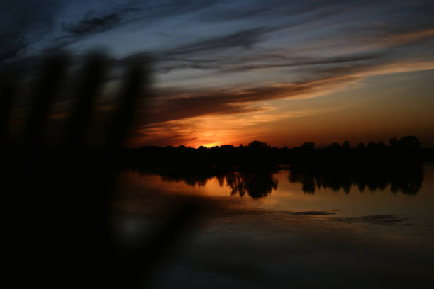 beautiful sunset on the river bank. dramatic sky of different colors. sunset